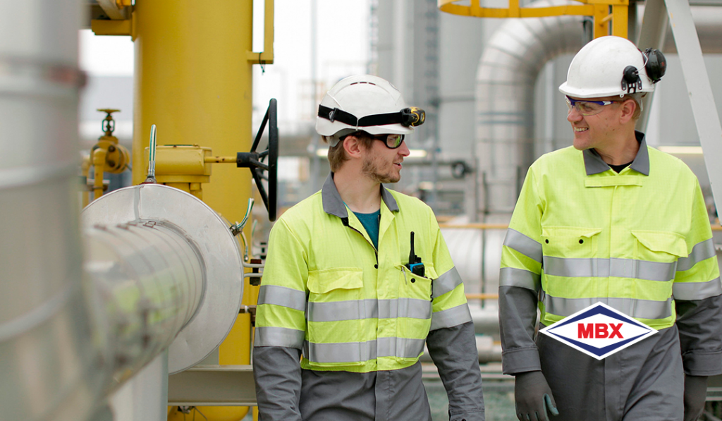 boilers - in the image there are two men in lime green safety clothing, with helmets